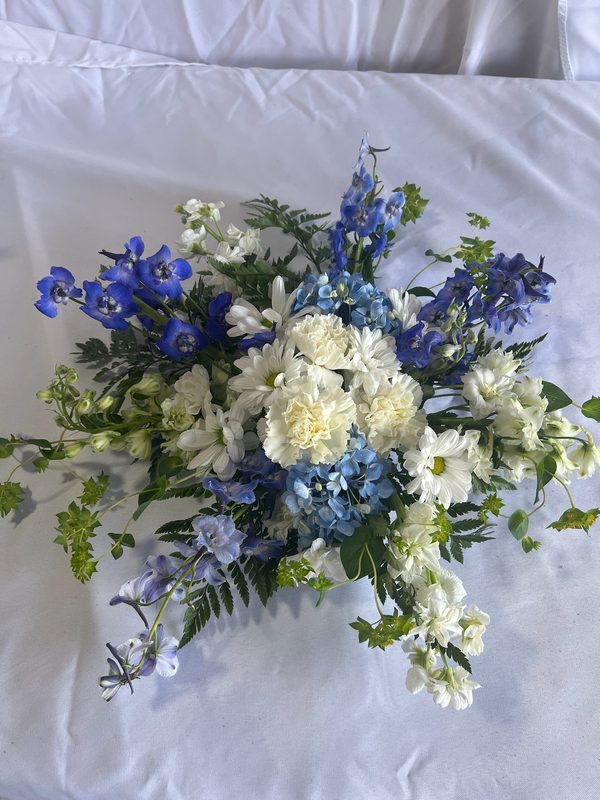 Blue delphinium and white carnation arrangement