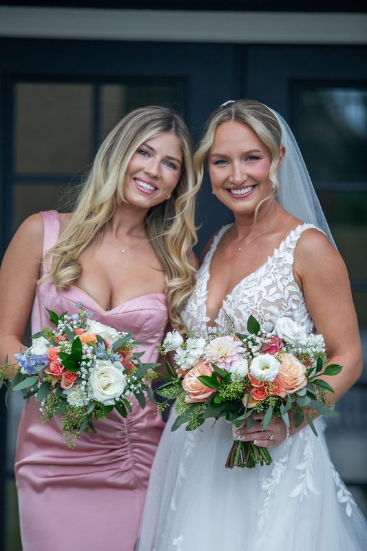 Bride and bridesmaid holding coordinating bouquets