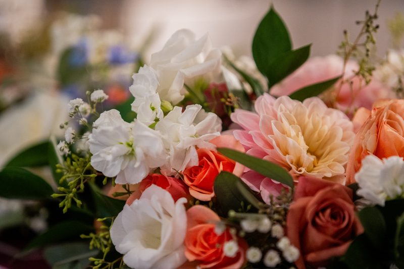 Close-up of white, peach and coral blooms in a bridal bouquet
